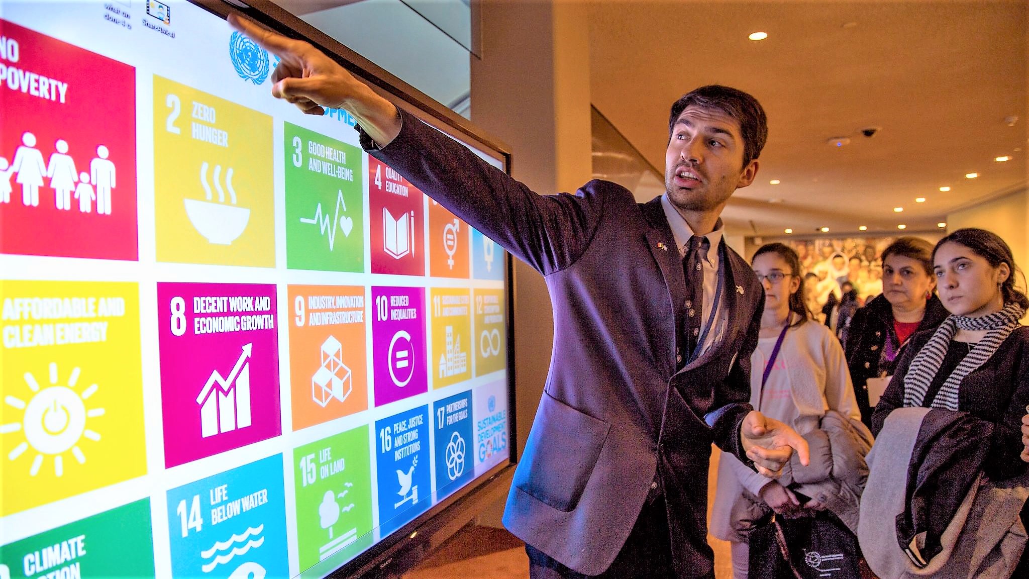 En mand peger på en skærm, der viser FN's 17 verdensmål for bæredygtig udvikling